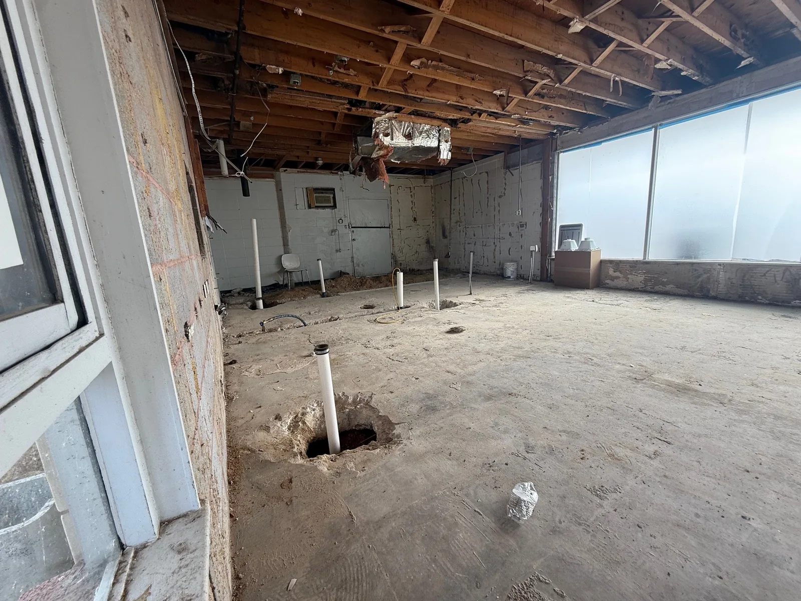 New plumbing roughed in through the concrete slab.