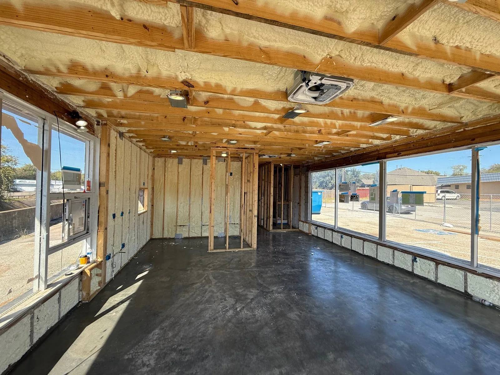 Fresh spray-foam insulation and new framing as the rebuild takes shape.